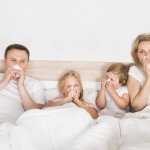 family in bed with a cold
