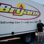 What Is A Propane Fixed Price Program?- Bryan's Fuel team member standing by their truck