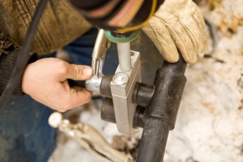 A technician working on a residential geothermal heating system.