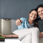 A photo of a happy couple sitting on the couch, along side an image of a Lennox Heat Pump and Furnace.
