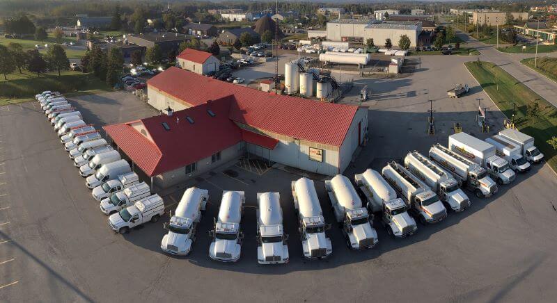 An aerial view of Byan's Fuel with a variety of fuel and service trucks lined up in their parking lot.