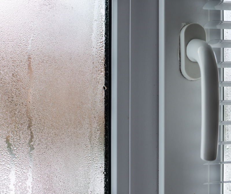 A photo of a window pane glass with condensation on it.