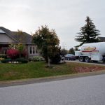 A photo of a Bryan's Fuel propane delivery truck in the driveway of a rural home.