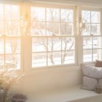 A photo of a large window in a home, looking out to a winter landscape.