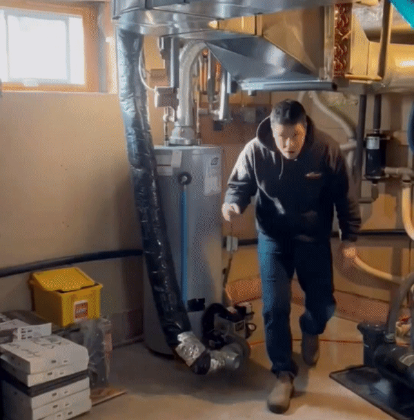 A gif of a Bryan's Fuel employee installing a new water heater system.