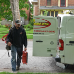 Bryan's Feul employee carry equipment from the truck.