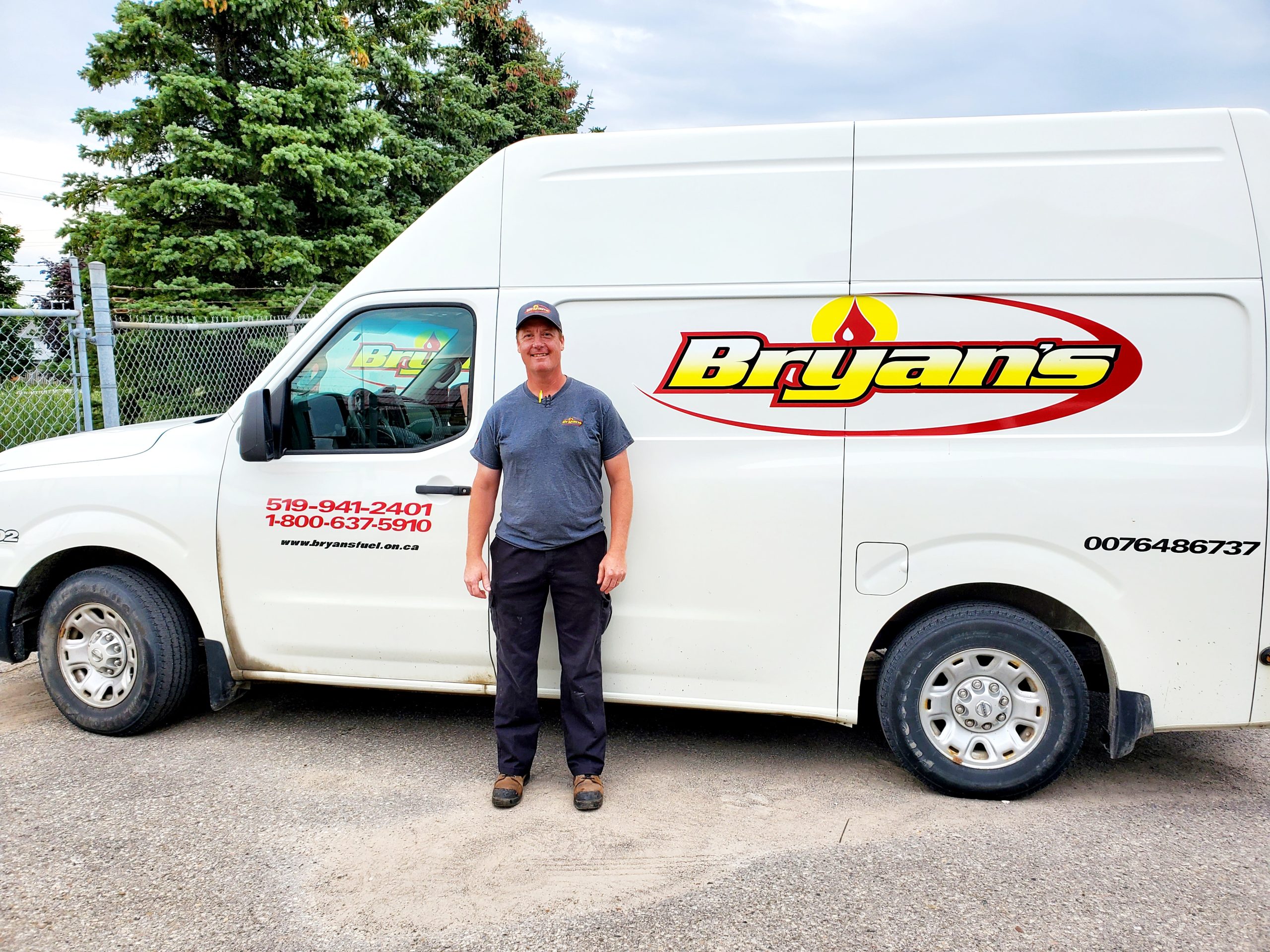 Bryan's Fuel team member in front of the company truck.