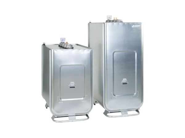 Two industrial metal tanks with rectangular shapes are positioned on pallet bases. Their surfaces are shiny and reflective, suitable for storage or transport.