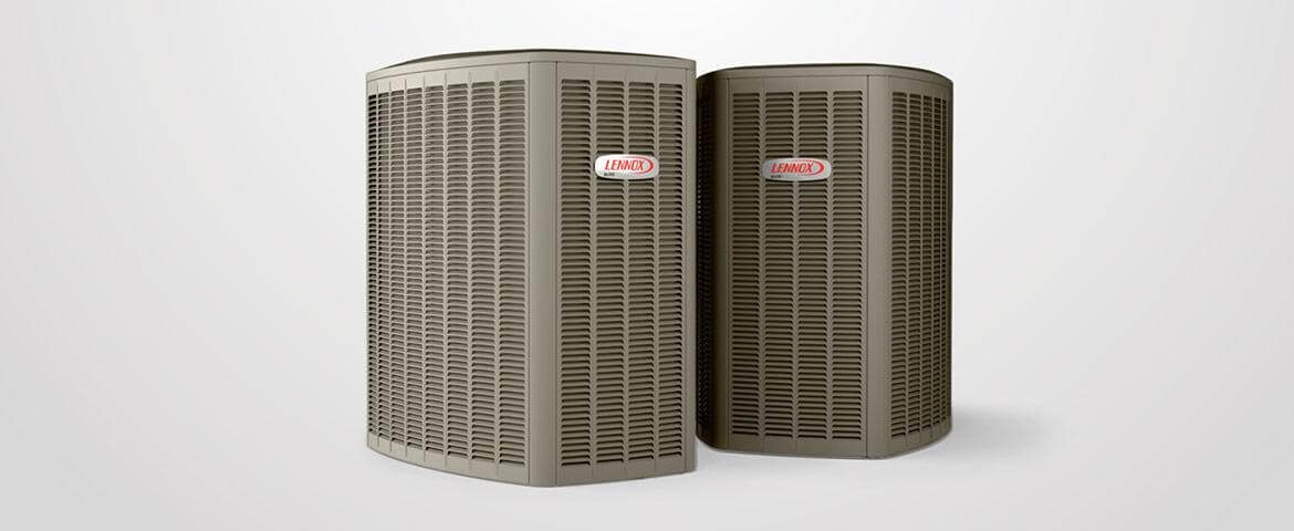Two Lennox air conditioning units are positioned side by side against a plain white background, highlighting their sleek, modern design and functionality.