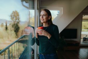 A photo of a woman looking out a window.
