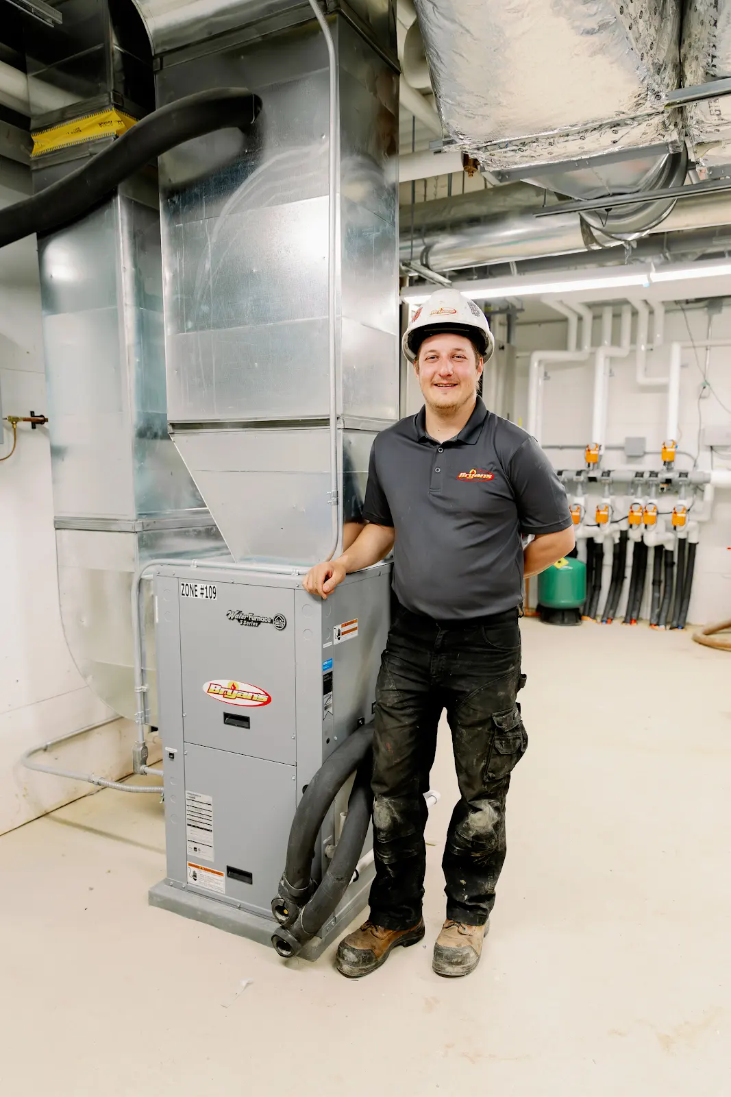 One of the Bryan's Fuel Team members standing by a duct after a successful duct cleaning appointment.