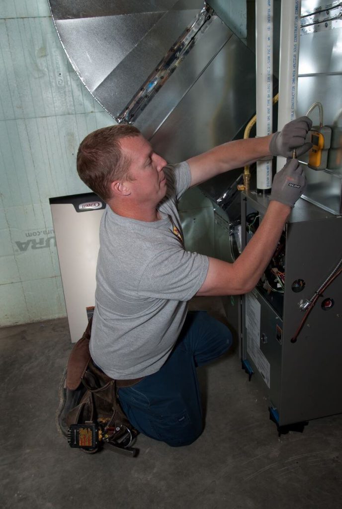 A man installing a new furnace. 