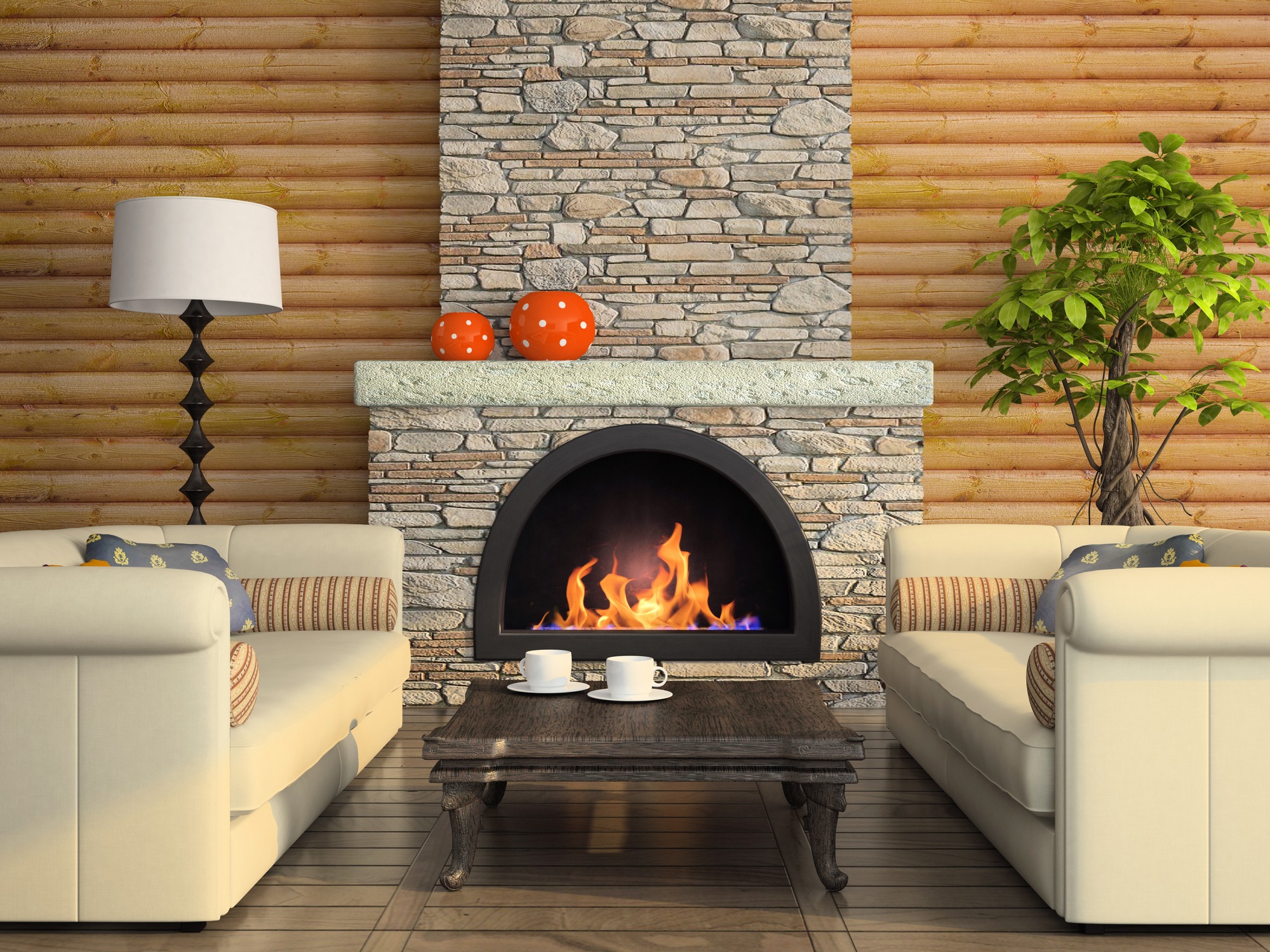 Cozy living room with a stone fireplace, two cream sofas, a wooden table, potted plant, and decorative lamps, exuding warmth and comfort.