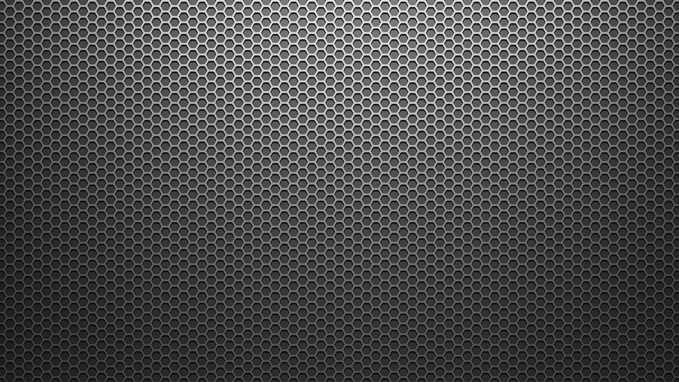 A metal surface with a geometric honeycomb pattern, featuring hexagonal cutouts, creating a textured, industrial look. No landmarks or buildings visible.