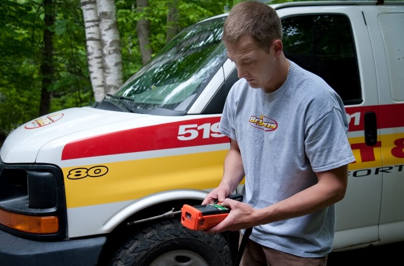 A photo of a Bryan's Fuel HVAC Technician standing in front of a company vehicle.