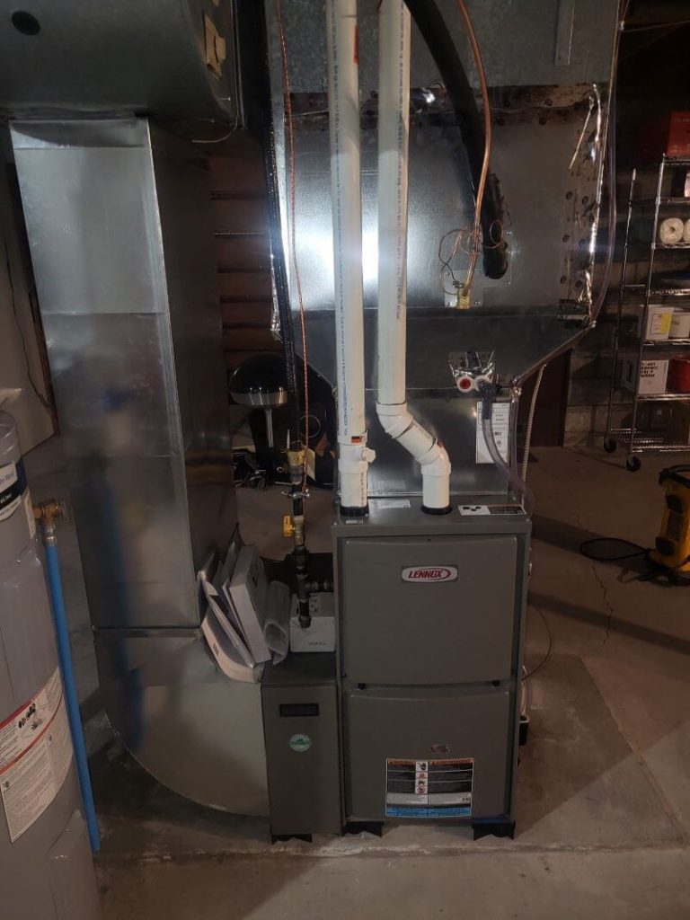 A Lennox furnace installed in a basement of a home.