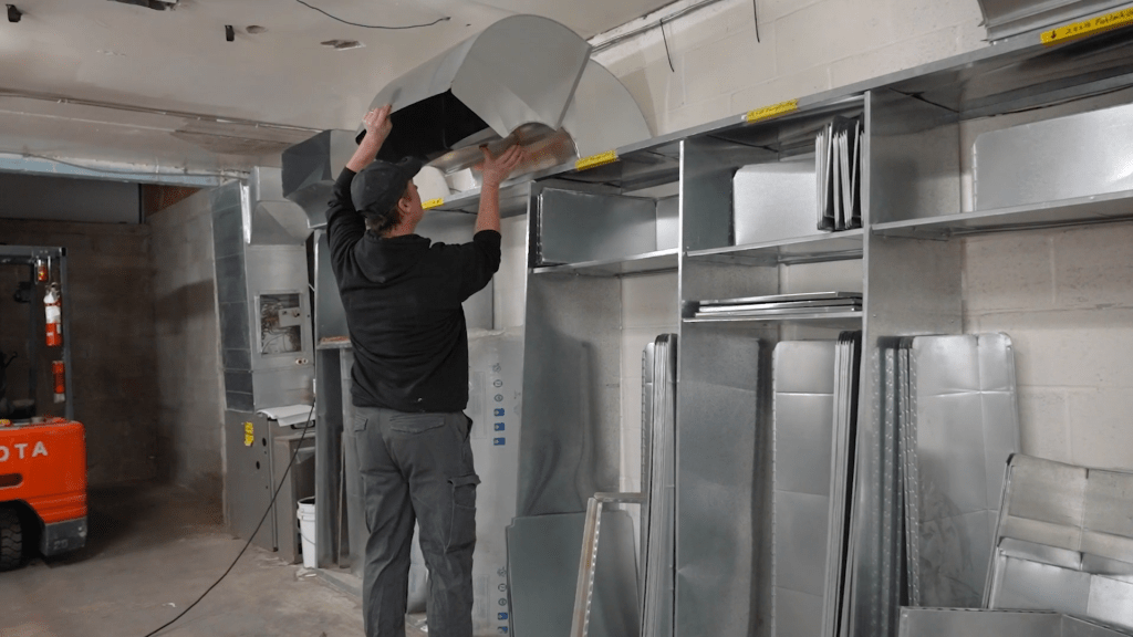 Bryan's Fuel employee installing HVAC vents.