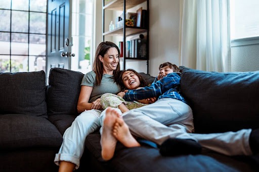 Family cuddling on couch