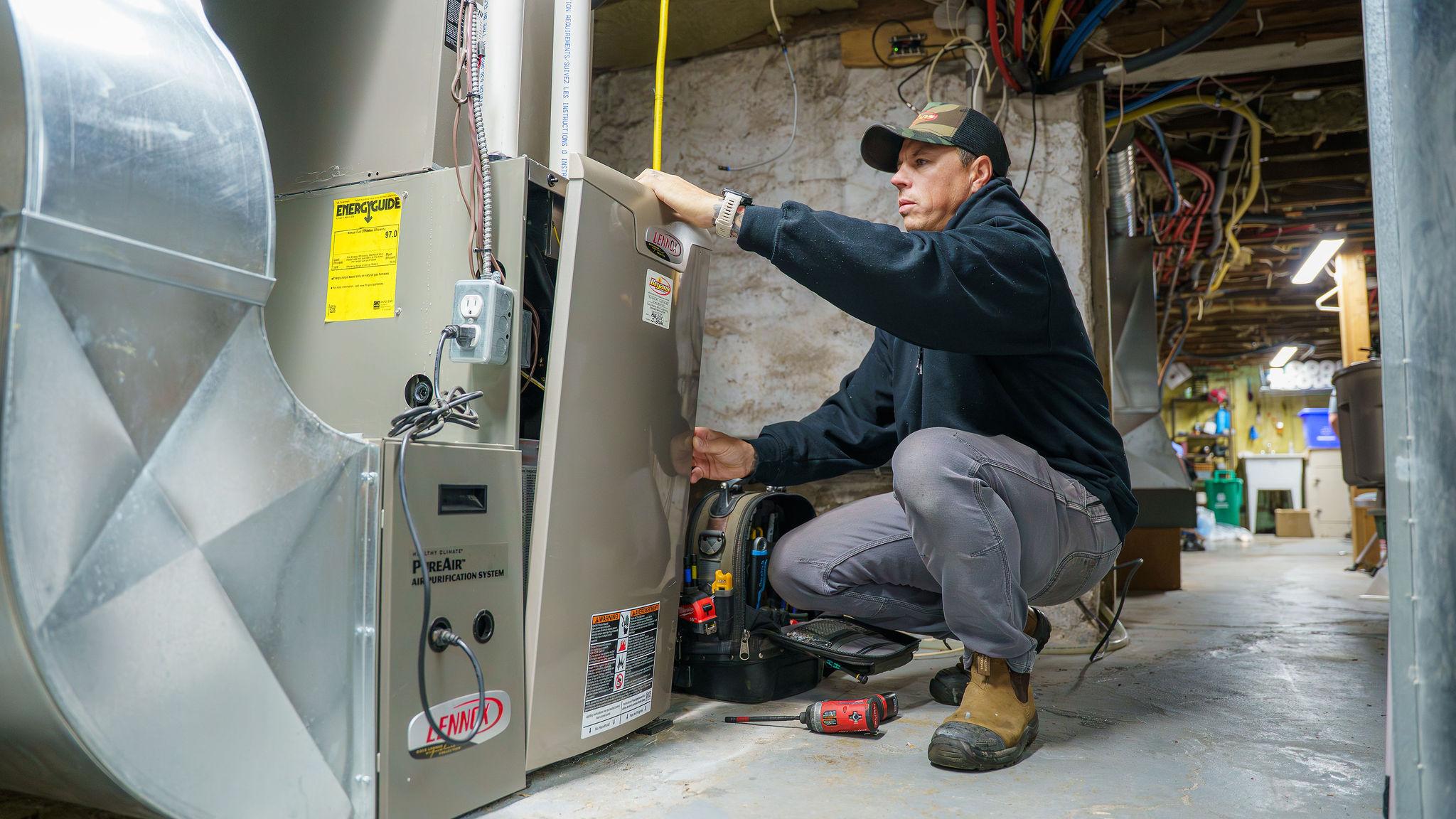Bryan's Fuel technichian servicing a furnace.