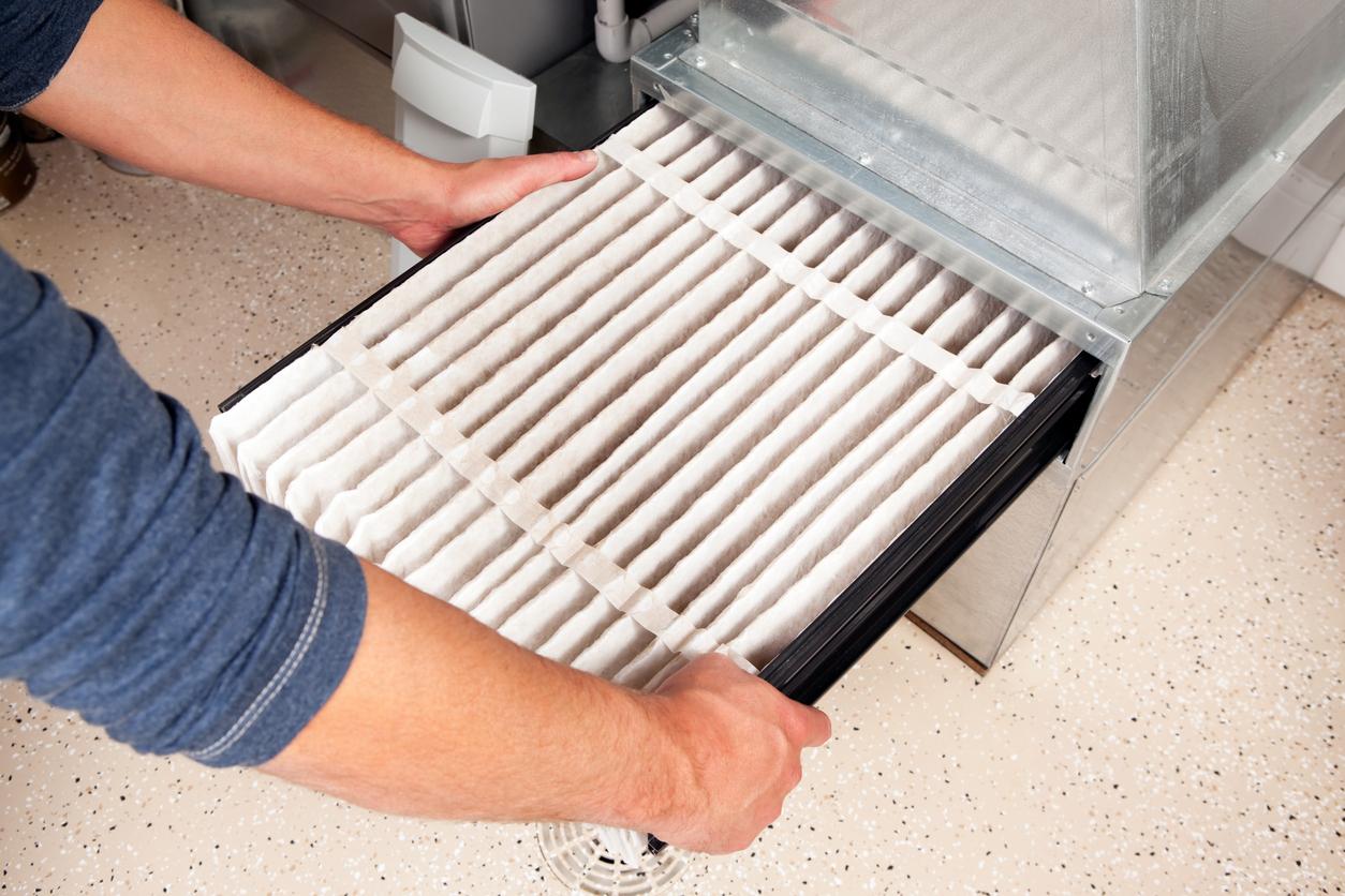 Changing a furnace filter.