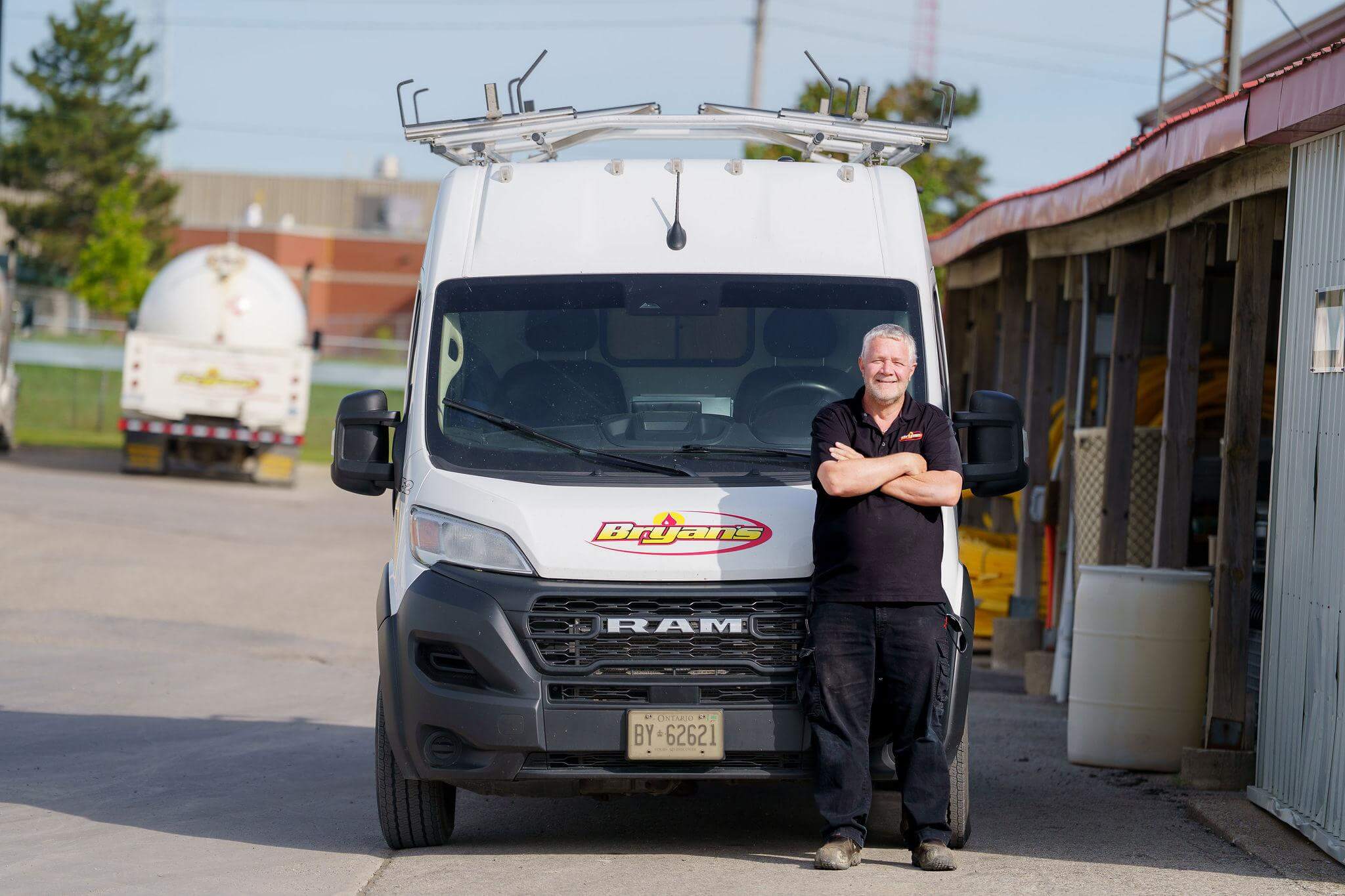 Bryan's Fuel technician in front of service van
