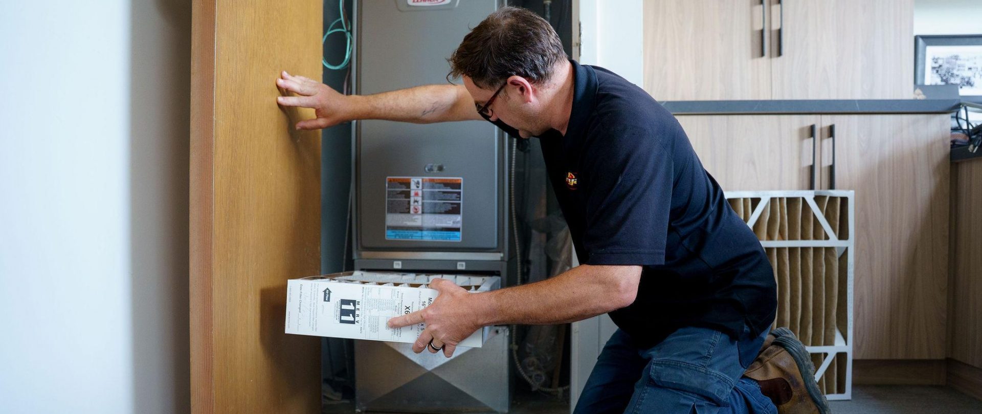 Bryan's Fuel technician installing new furnace filter.