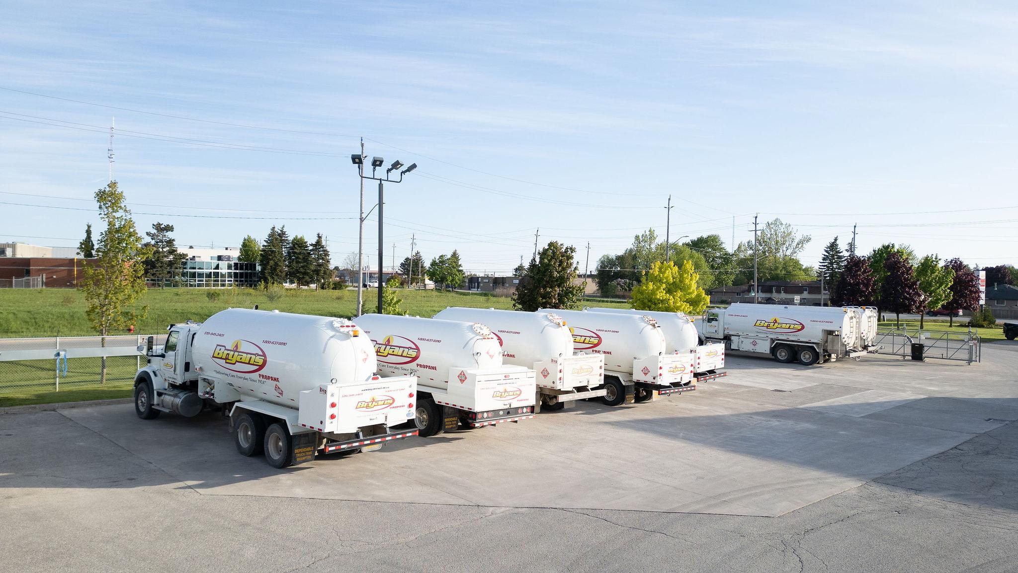 Bryan's Fuel propane trucks lined up in parking lot.